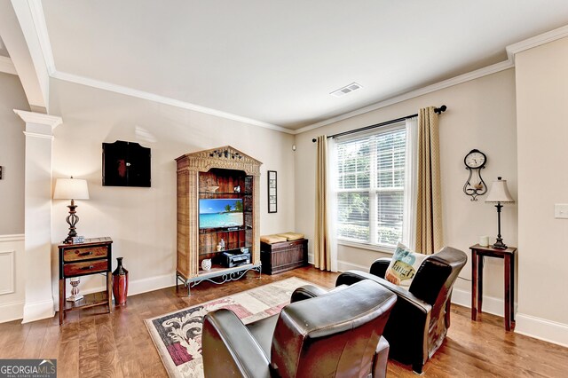 2325 Lake Cove Ct, Buford, GA 30519 - living room featuring wood finished floors, ornamental molding, and decorative columns
