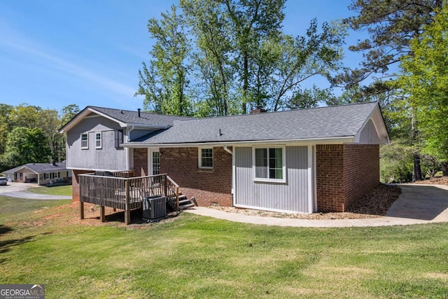 15 Cedar Ln E, Newnan, GA 30263 - rear view of house featuring a wooden deck, brick siding, and a yard
