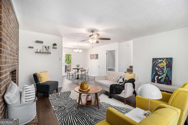 15 Cedar Ln E, Newnan, GA 30263 - living area with wood finished floors, stairway, a chandelier, ceiling fan, and a fireplace
