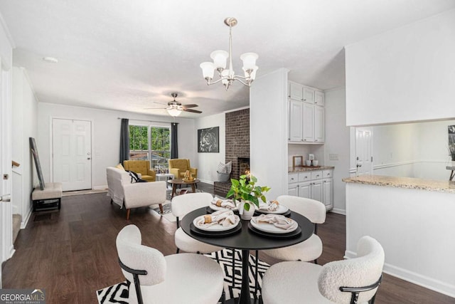 15 Cedar Ln E, Newnan, GA 30263 - dining room with a chandelier, dark wood-style floors, a fireplace, and ceiling fan