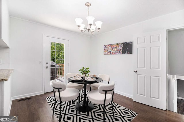 15 Cedar Ln E, Newnan, GA 30263 - dining space featuring a chandelier, crown molding, and dark wood-type flooring