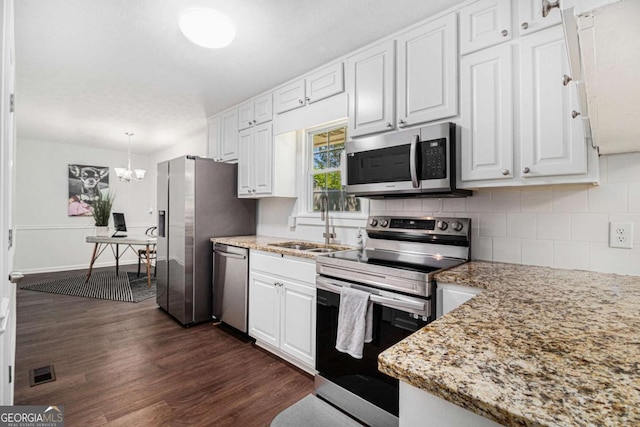 15 Cedar Ln E, Newnan, GA 30263 - kitchen featuring stainless steel appliances, dark wood finished floors, white cabinets, and backsplash