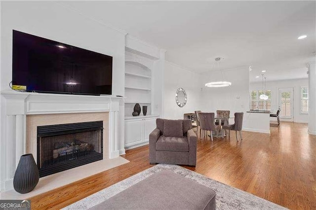 4089 Thorndale Ln Unit 13, Smyrna, GA 30080 - living area featuring wood finished floors, built in shelves, and a fireplace with flush hearth
