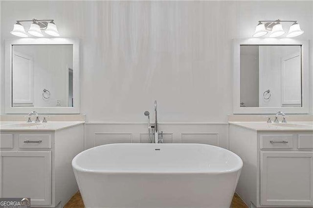 4089 Thorndale Ln Unit 13, Smyrna, GA 30080 - full bath with two vanities, a freestanding bath, and wainscoting