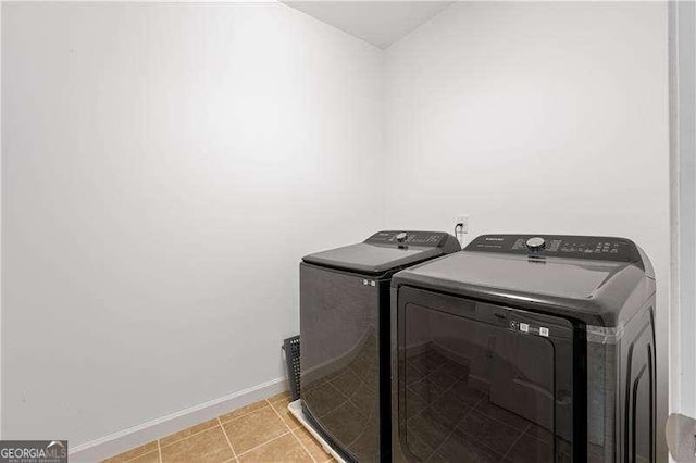 4089 Thorndale Ln Unit 13, Smyrna, GA 30080 - laundry room with washing machine and dryer and light tile patterned flooring