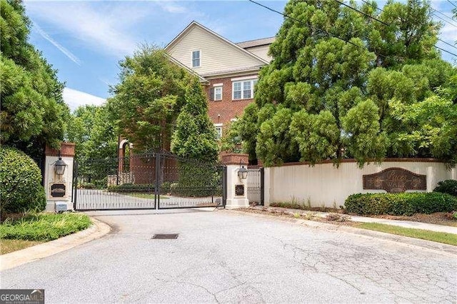 4089 Thorndale Ln Unit 13, Smyrna, GA 30080 - view of asphalt street with a gate, curbs, a gated entry, and sidewalks