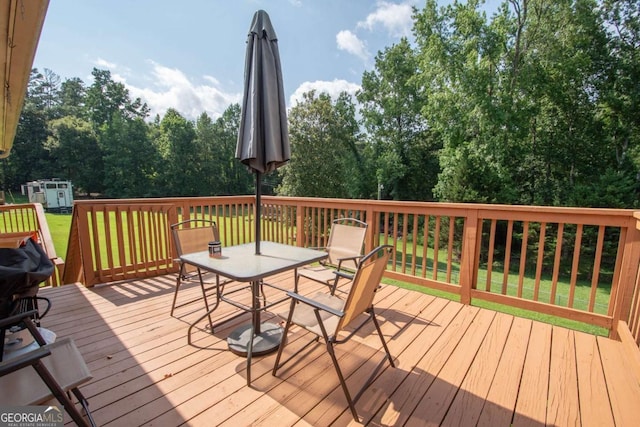 128 Robinhood Dr, Newnan, GA 30263 - wooden terrace featuring outdoor dining space and a lawn