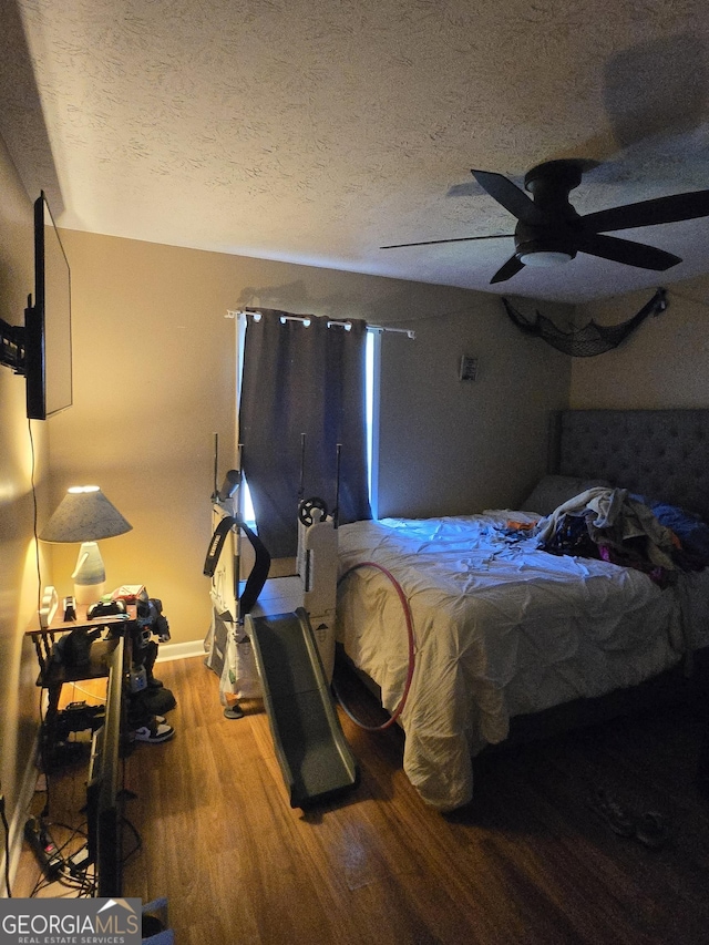 8778 Homewood Ct, Riverdale, GA 30274 - bedroom featuring a textured ceiling, wood finished floors, and ceiling fan