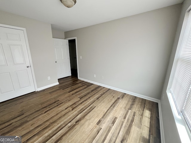 1050 Wheel House Ln Unit A, Monroe, GA 30655 - unfurnished bedroom with wood finished floors and baseboards