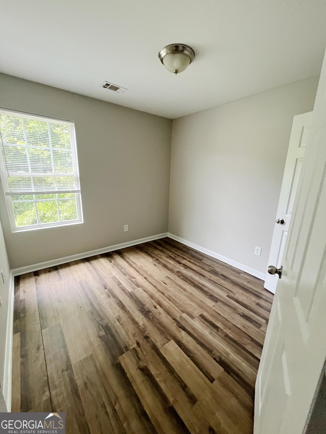 1050 Wheel House Ln Unit A, Monroe, GA 30655 - spare room with dark wood-style floors and baseboards