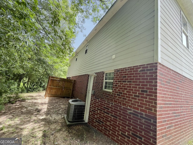 1050 Wheel House Ln Unit A, Monroe, GA 30655 - view of home's exterior featuring a central AC unit and brick siding