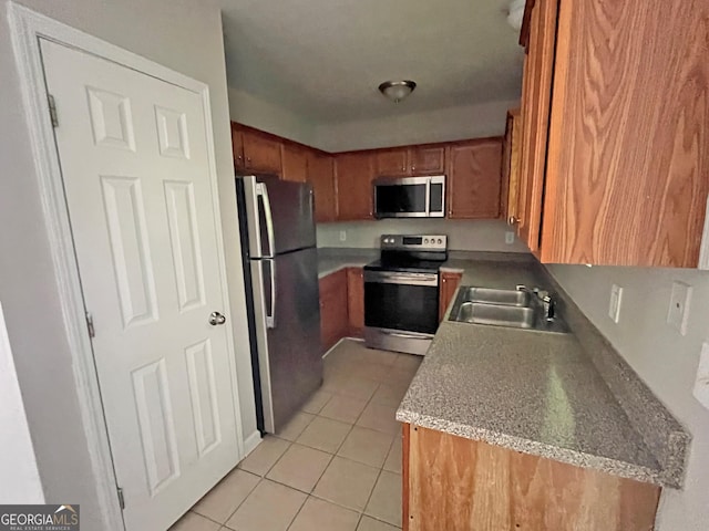 1050 Wheel House Ln Unit A, Monroe, GA 30655 - kitchen featuring stainless steel appliances, light tile patterned floors, brown cabinets, and light countertops