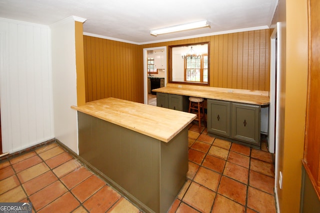 2202 Springdale Dr, Snellville, GA 30078 - kitchen with wood counters, ornamental molding, a peninsula, and wooden walls