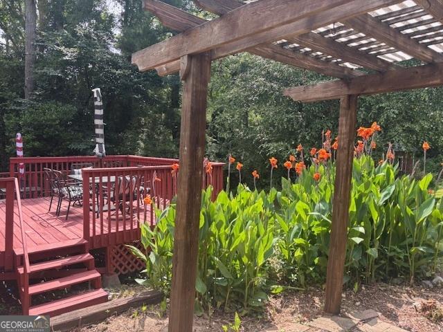 2202 Springdale Dr, Snellville, GA 30078 - wooden deck with a pergola and outdoor dining area