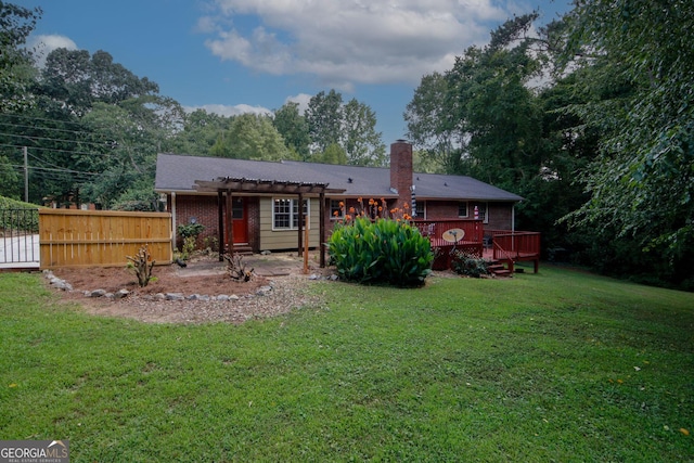 2202 Springdale Dr, Snellville, GA 30078 - back of property with a pergola, brick siding, a chimney, a wooden deck, and a patio