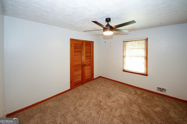 2202 Springdale Dr, Snellville, GA 30078 - carpeted empty room with a ceiling fan and a textured ceiling