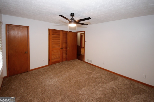2202 Springdale Dr, Snellville, GA 30078 - unfurnished bedroom with carpet, a textured ceiling, a closet, and ceiling fan