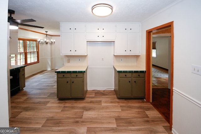 2202 Springdale Dr, Snellville, GA 30078 - kitchen featuring a ceiling fan, a chandelier, white cabinets, plenty of natural light, and ornamental molding