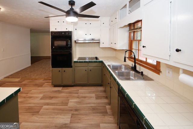 2202 Springdale Dr, Snellville, GA 30078 - kitchen with tile countertops, a ceiling fan, under cabinet range hood, white cabinets, and light wood-style floors