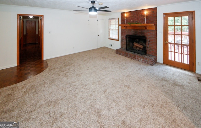 2202 Springdale Dr, Snellville, GA 30078 - unfurnished living room with a fireplace, ceiling fan, crown molding, and carpet