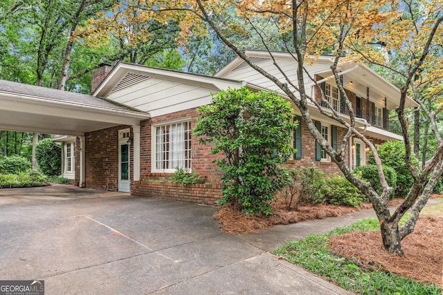 175 Cedar Creek Dr, Athens, GA 30605 - view of side of property featuring brick siding, a chimney, and concrete driveway