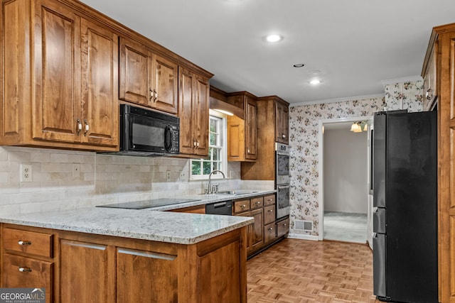175 Cedar Creek Dr, Athens, GA 30605 - kitchen featuring black appliances, brown cabinetry, wallpapered walls, ornamental molding, and backsplash