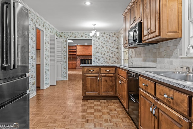 175 Cedar Creek Dr, Athens, GA 30605 - kitchen featuring black appliances, wallpapered walls, brown cabinetry, a peninsula, and a chandelier