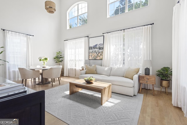 300 Brickworks Cir NE # 302, Atlanta, GA 30307 - living room featuring a towering ceiling and light wood finished floors