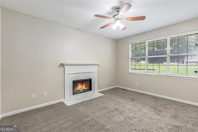 7420 Bristol, Douglasville, GA 30134 - unfurnished living room featuring carpet, a ceiling fan, a premium fireplace, and a textured ceiling