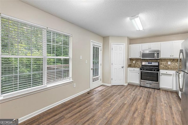 7420 Bristol, Douglasville, GA 30134 - kitchen featuring stainless steel appliances, dark wood-type flooring, white cabinetry, decorative backsplash, and a textured ceiling