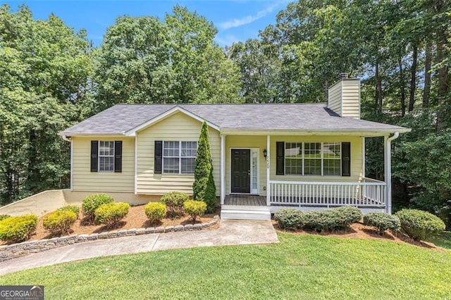 7420 Bristol, Douglasville, GA 30134 - view of front of home with covered porch, a front lawn, and a chimney