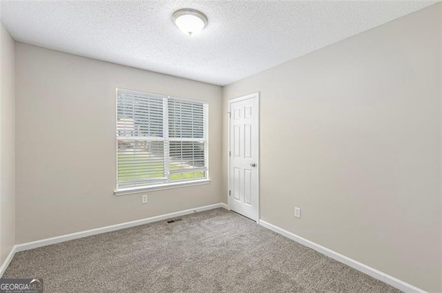 7420 Bristol, Douglasville, GA 30134 - carpeted spare room featuring baseboards and a textured ceiling
