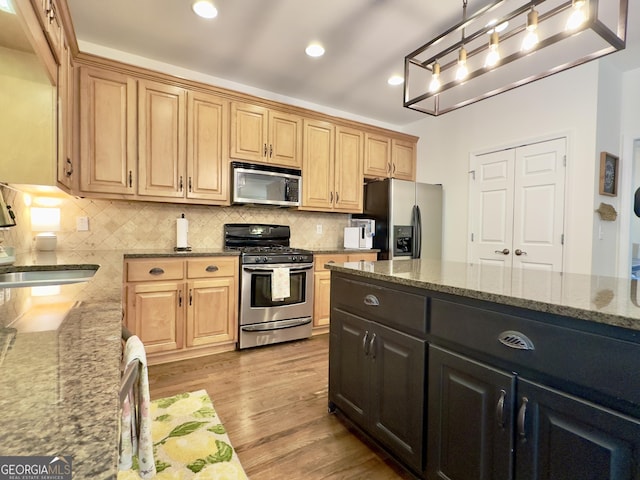 48 Red Bud Ln, Dallas, GA 30132 - kitchen with stainless steel appliances, light stone counters, light wood-type flooring, backsplash, and recessed lighting