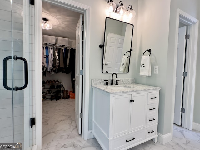 48 Red Bud Ln, Dallas, GA 30132 - full bath featuring marble look tiles, vanity, a walk in closet, and a stall shower