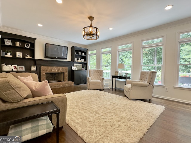 48 Red Bud Ln, Dallas, GA 30132 - living room with crown molding, a fireplace, recessed lighting, wood finished floors, and a chandelier