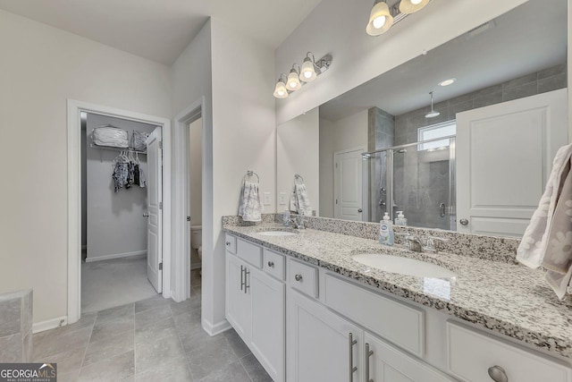 320 Pebblestone Ln, Canton, GA 30115 - full bathroom featuring a stall shower, double vanity, and a walk in closet