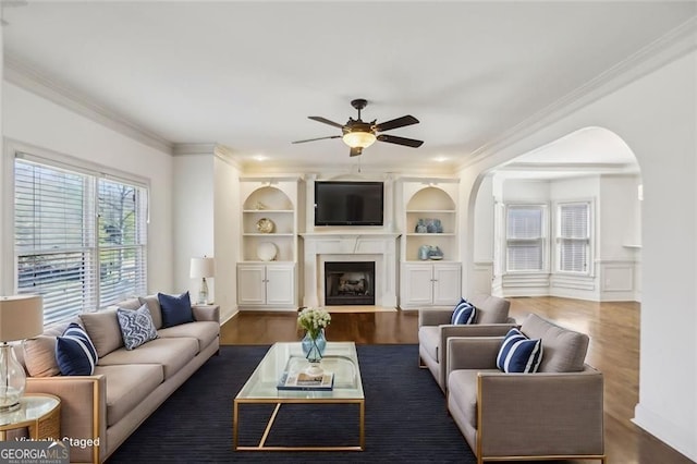 2108 Main St NW, Atlanta, GA 30318 - living area with a ceiling fan, arched walkways, wood finished floors, a fireplace, and crown molding