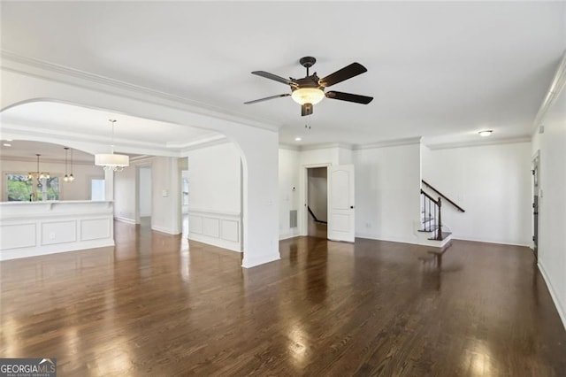 2108 Main St NW, Atlanta, GA 30318 - unfurnished living room with arched walkways, a ceiling fan, crown molding, wood finished floors, and stairway
