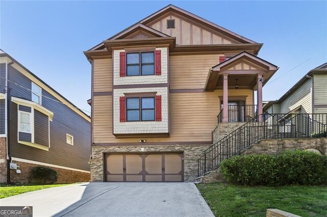2108 Main St NW, Atlanta, GA 30318 - view of front of home featuring a garage, board and batten siding, stairs, and concrete driveway