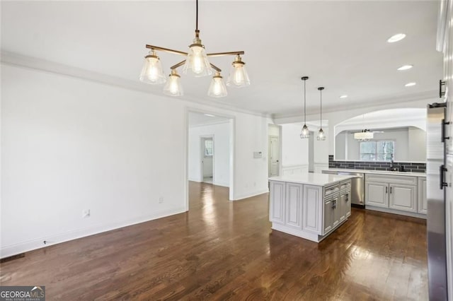 2108 Main St NW, Atlanta, GA 30318 - kitchen featuring arched walkways, stainless steel dishwasher, a chandelier, crown molding, and dark wood-style flooring