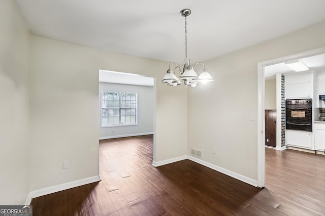 1517 Indian Forest Trl, Stone Mountain, GA 30083 - empty room featuring a chandelier and dark wood finished floors