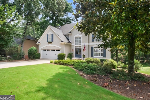 6380 Bannerhorn Run, Alpharetta, GA 30005 - traditional home featuring concrete driveway, stucco siding, a front yard, and a garage