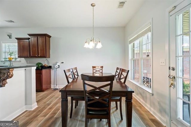 1147 Scenic Park Trl, Lawrenceville, GA 30046 - dining room with light wood-type flooring, plenty of natural light, and a chandelier
