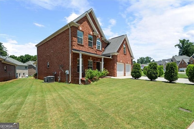 1147 Scenic Park Trl, Lawrenceville, GA 30046 - rear view of house featuring brick siding, a yard, a garage, and driveway