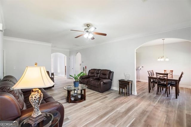 1147 Scenic Park Trl, Lawrenceville, GA 30046 - living area with arched walkways, a ceiling fan, light wood-type flooring, ornamental molding, and a chandelier
