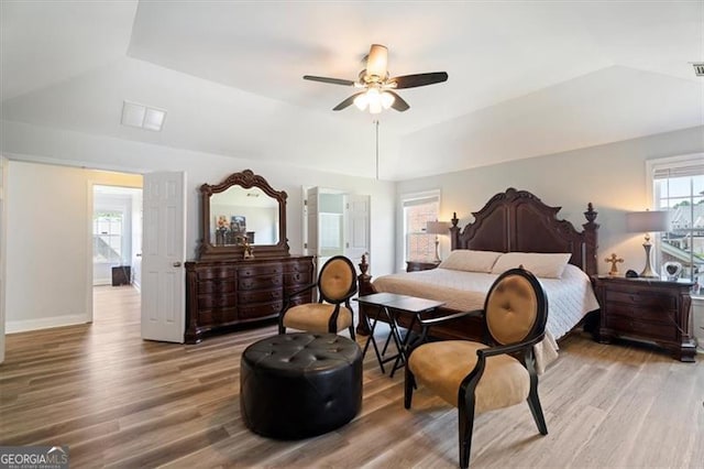 1147 Scenic Park Trl, Lawrenceville, GA 30046 - bedroom with light wood finished floors, lofted ceiling, a tray ceiling, and a ceiling fan