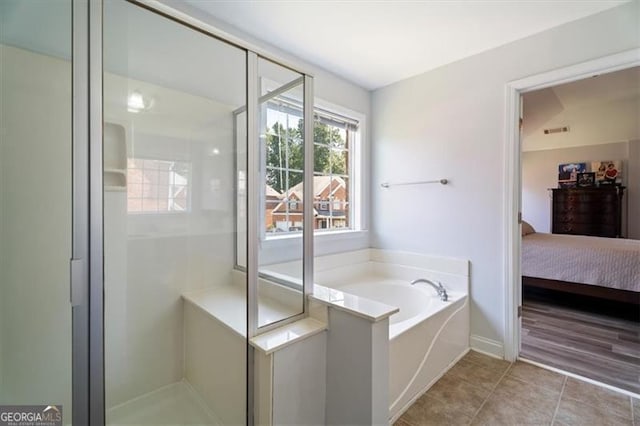 1147 Scenic Park Trl, Lawrenceville, GA 30046 - full bathroom featuring ensuite bathroom, a bath, a stall shower, and tile patterned floors