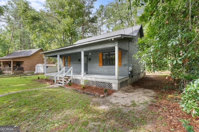 144 Winding Way, Statesboro, GA 30461 - view of front of home featuring a porch, a storage shed, a front lawn, and crawl space