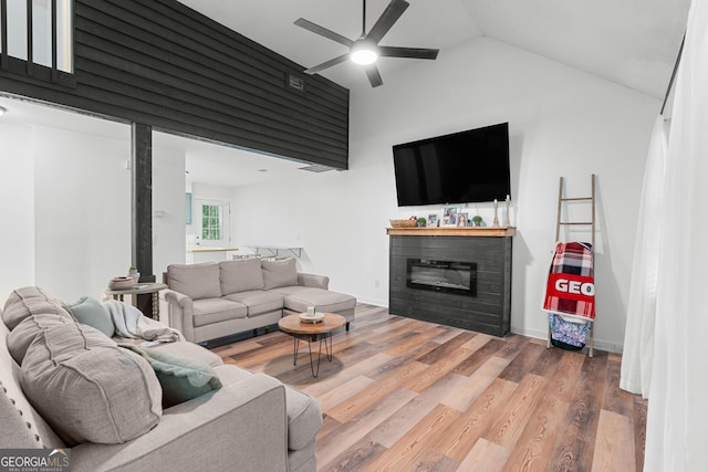 144 Winding Way, Statesboro, GA 30461 - living room featuring a ceiling fan, lofted ceiling, a glass covered fireplace, and wood finished floors