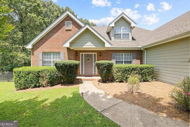 20 Knollwood Pl, Covington, GA 30014 - view of front of house featuring brick siding, a front yard, and a shingled roof
